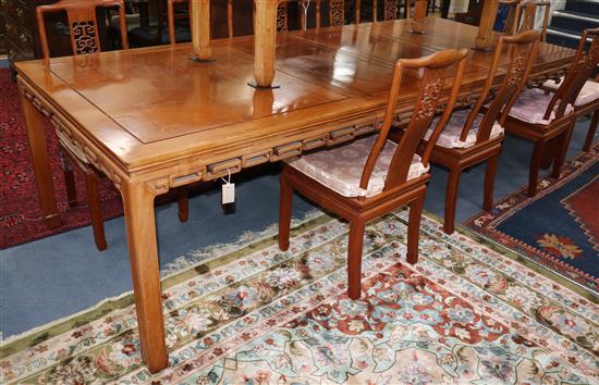 A Chinese hardwood extending dining table, with 2 spare leaves W.275cm